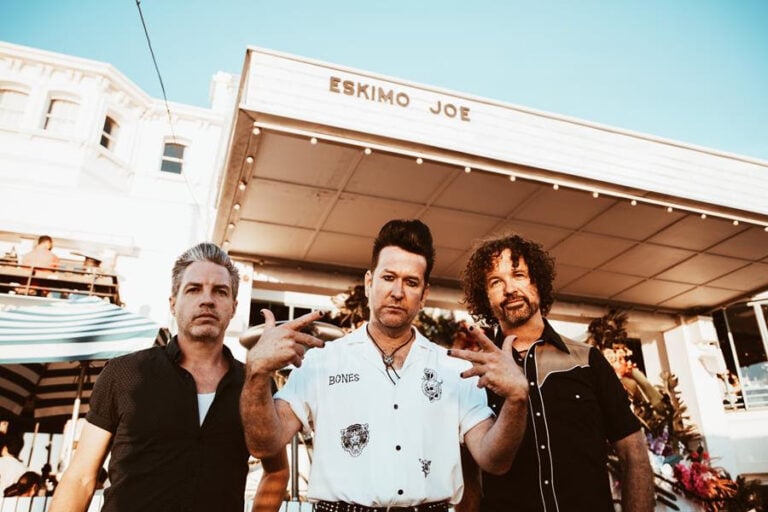 Eskimo Joe posing in front of a venue