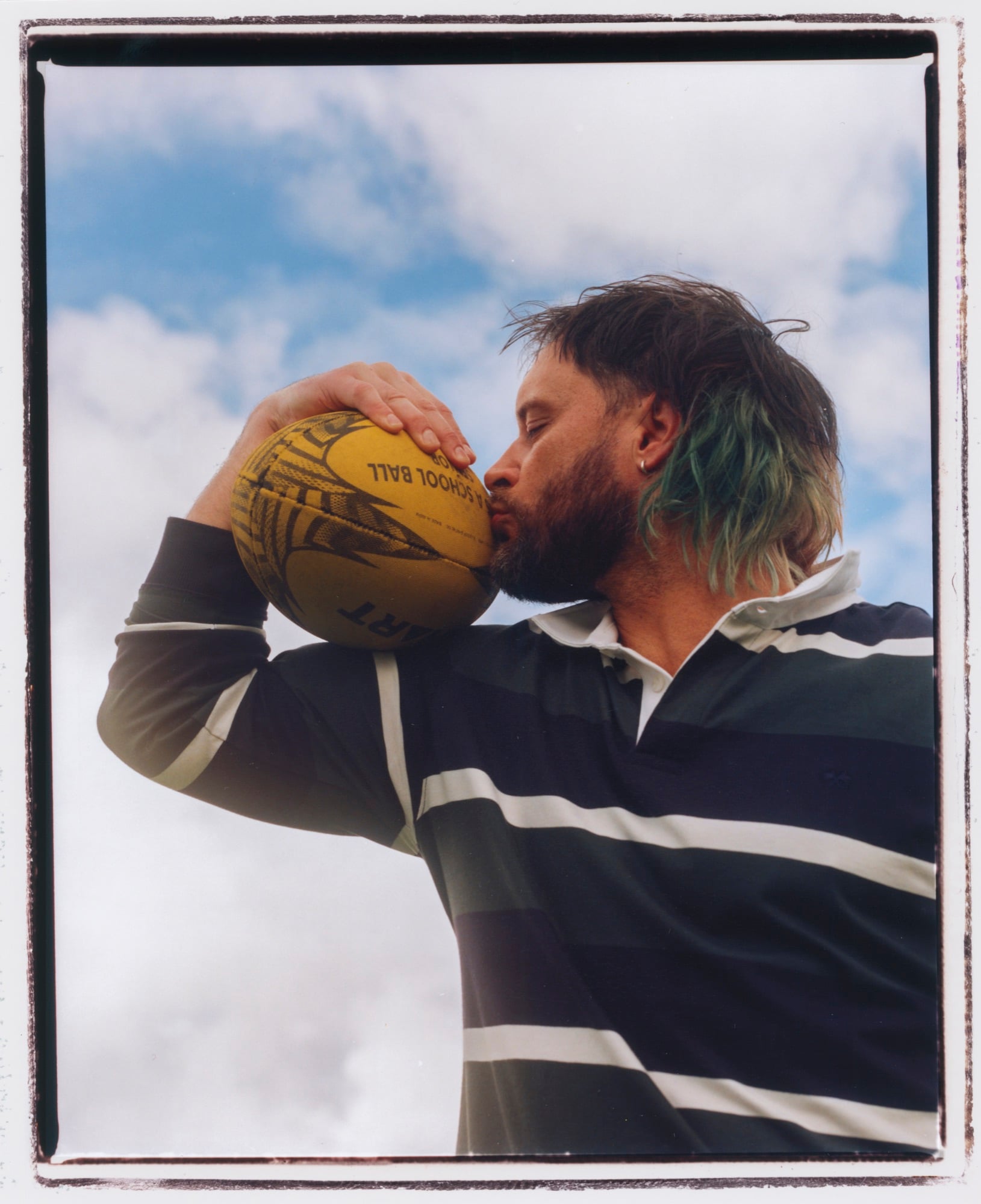 Mitch Brown kissing a football in a still from ‘Can’t Wait’.