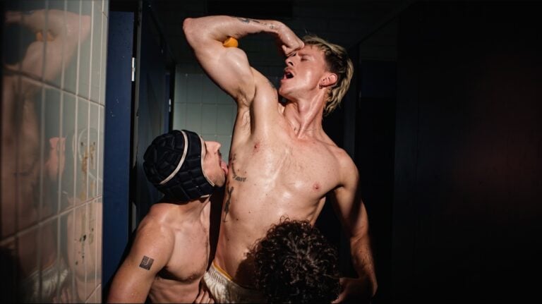 ANDY with other performers in a tiled room in the ‘Can’t Wait’ music video.