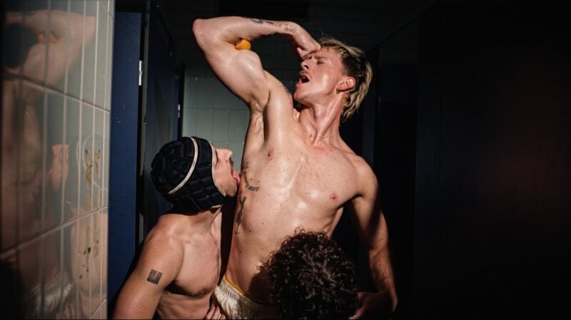 ANDY with other performers in a tiled room in the ‘Can’t Wait’ music video.