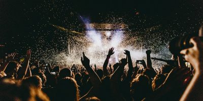 Image of a live gig at night, showing the sort of crowd that shows up at festivals