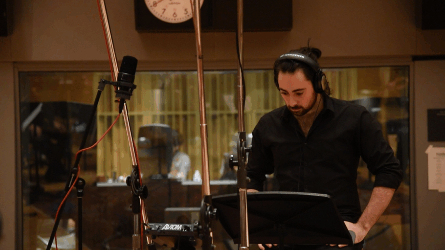 Kevin Penkin stands in a recording