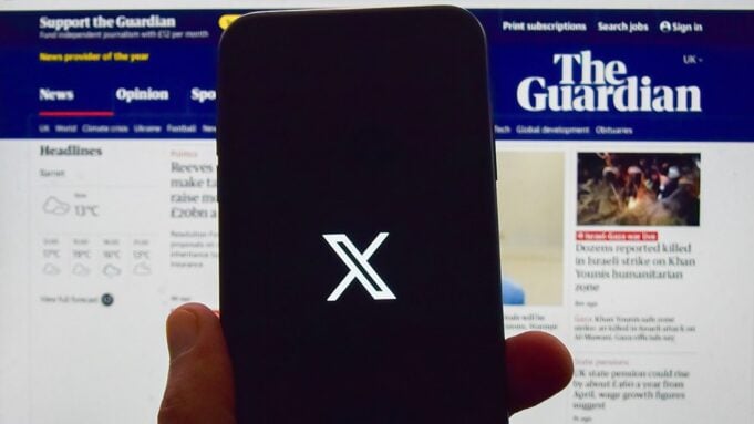 X/Twitter on mobile phone in front