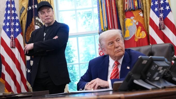 Elon Musk stands behind Donald Trump
