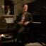 Ben Folds smiling at a piano