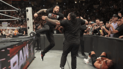 Roman Reigns hitting Bronson Reed