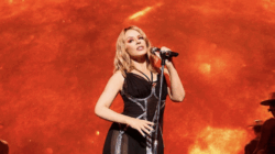 Kylie Minogue singing into a mic