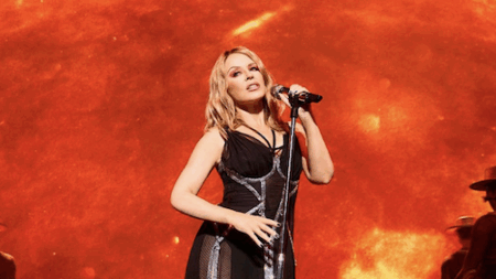 Kylie Minogue singing into a mic