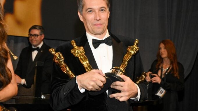 Sean Baker holding Oscars